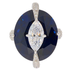 Elegant oval blue sapphire and diamond sterling silver ring, showcasing luxury and sophistication.