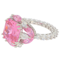 Elegant round pink sapphire sterling silver ring with sparkling accents, perfect for adding luxury to any outfit.