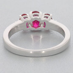 Elegant red ruby sterling silver ring showcasing three stones and a stunning accent detail.