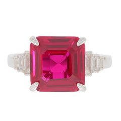 Emerald cut red ruby sterling silver ring with moissanite accents, showcasing luxury and elegance.