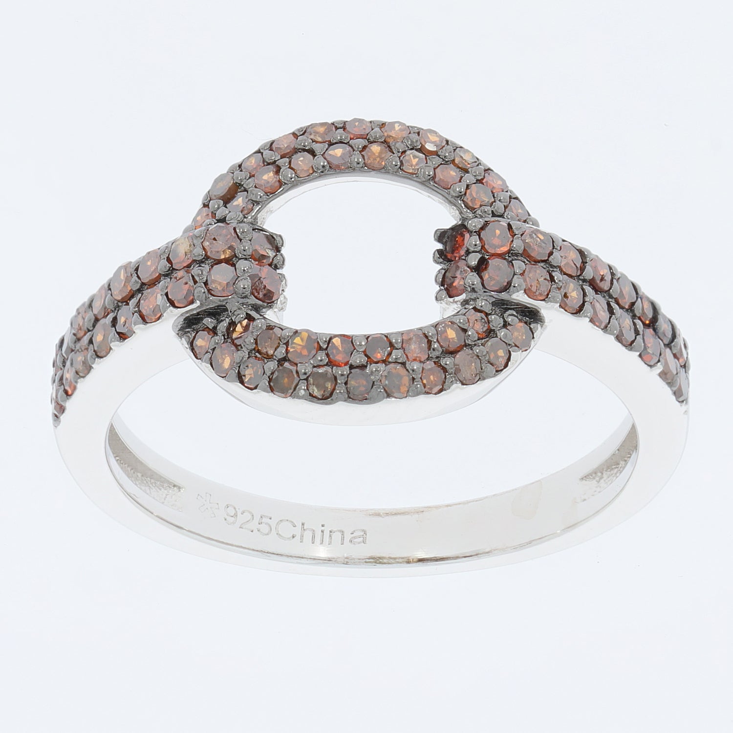 Elegant sterling silver ring with sparkling brown gemstones in a unique interlocking design.