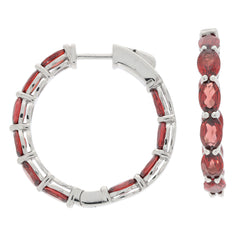 Oval red garnet sterling silver earrings, featuring a stylish hoop design and sparkling gemstone accents.