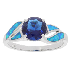 Blue sapphire sterling silver ring with accent stones, featuring a round brilliant cut gemstone.