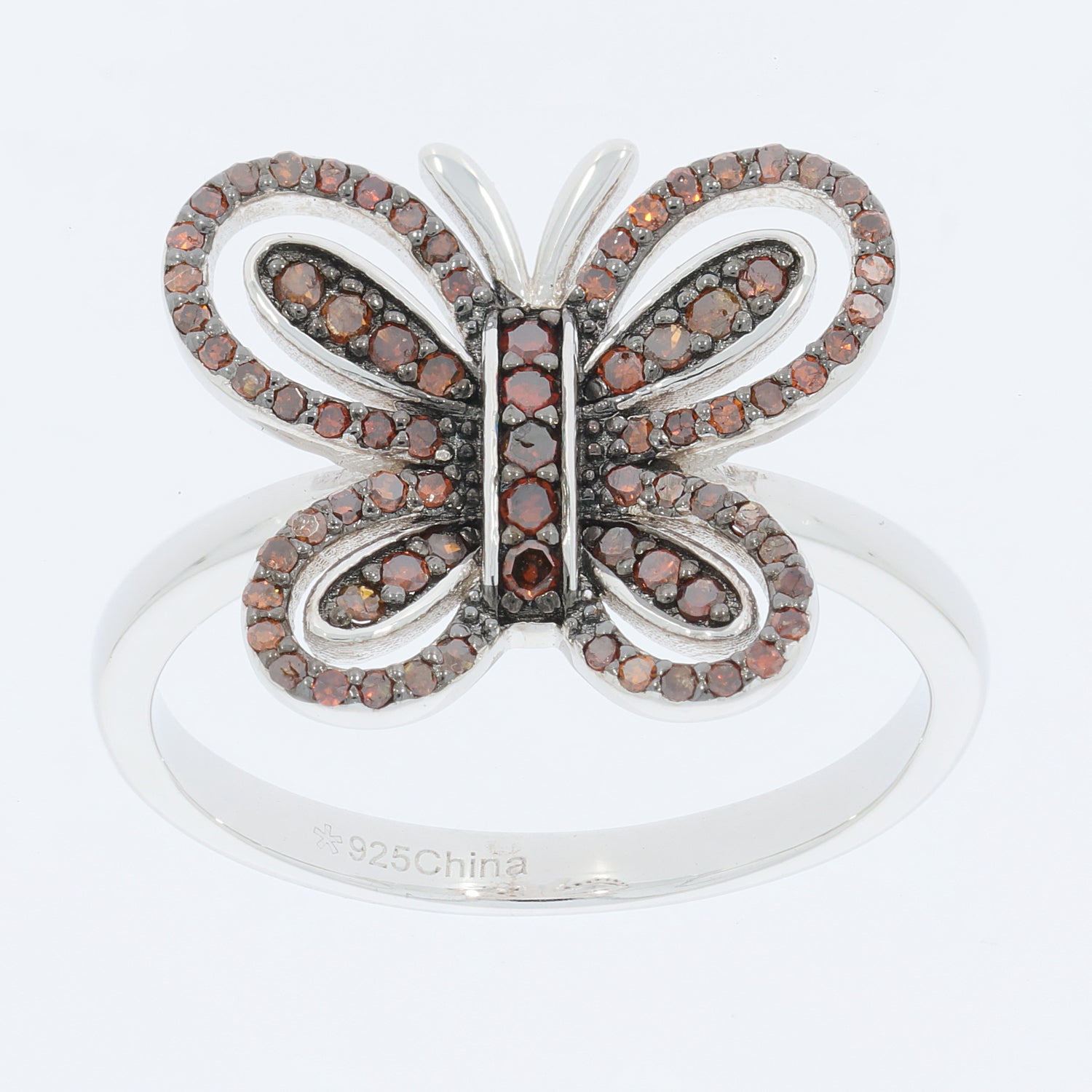 Butterfly ring in sterling silver with sparkling red gemstones, perfect for elegant style and luxury.