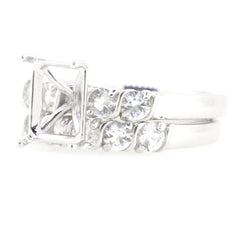 Sterling silver semi mount ring setting with white topaz gemstones, designed for a 9x7mm emerald centerpiece.