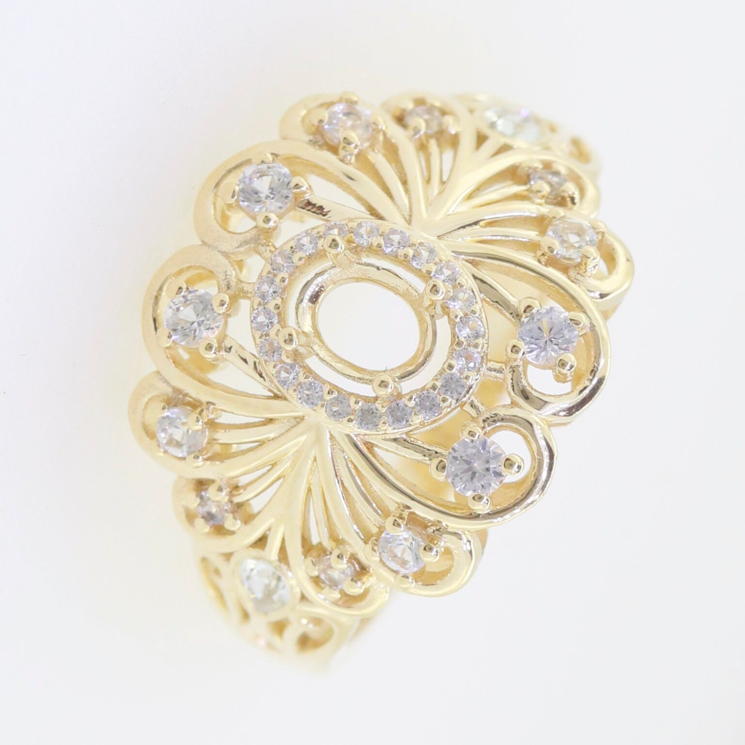 Elegant yellow gold ring setting featuring intricate filigree and sparkling gemstones for a unique jewelry design.
