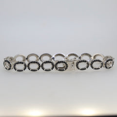 Sterling silver semi mount tennis bracelet setting with oval halo and black spinel accents, stainless steel tongue for durability.