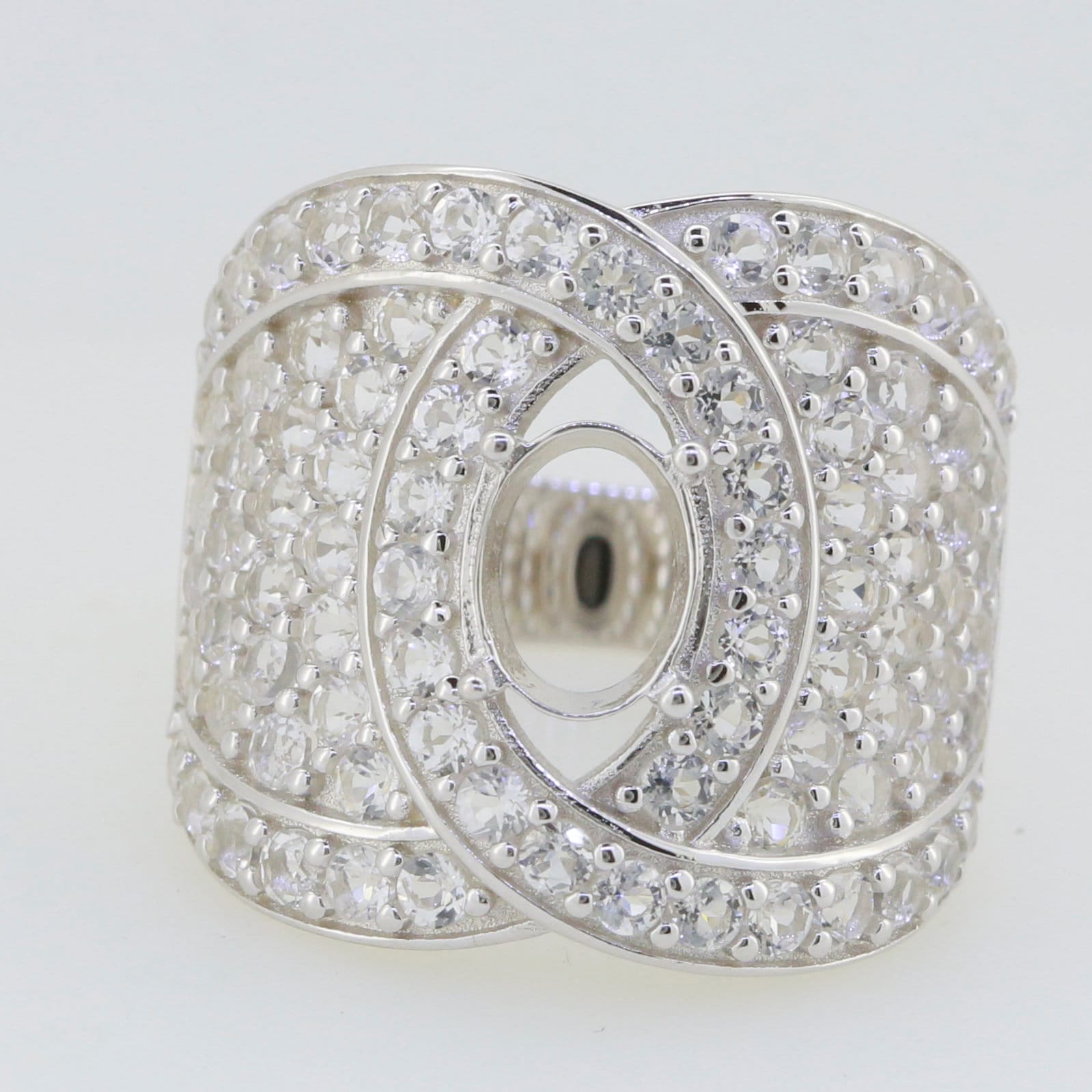 Sterling silver dome cocktail ring setting with white topaz accents, featuring an elegant intertwined design.
