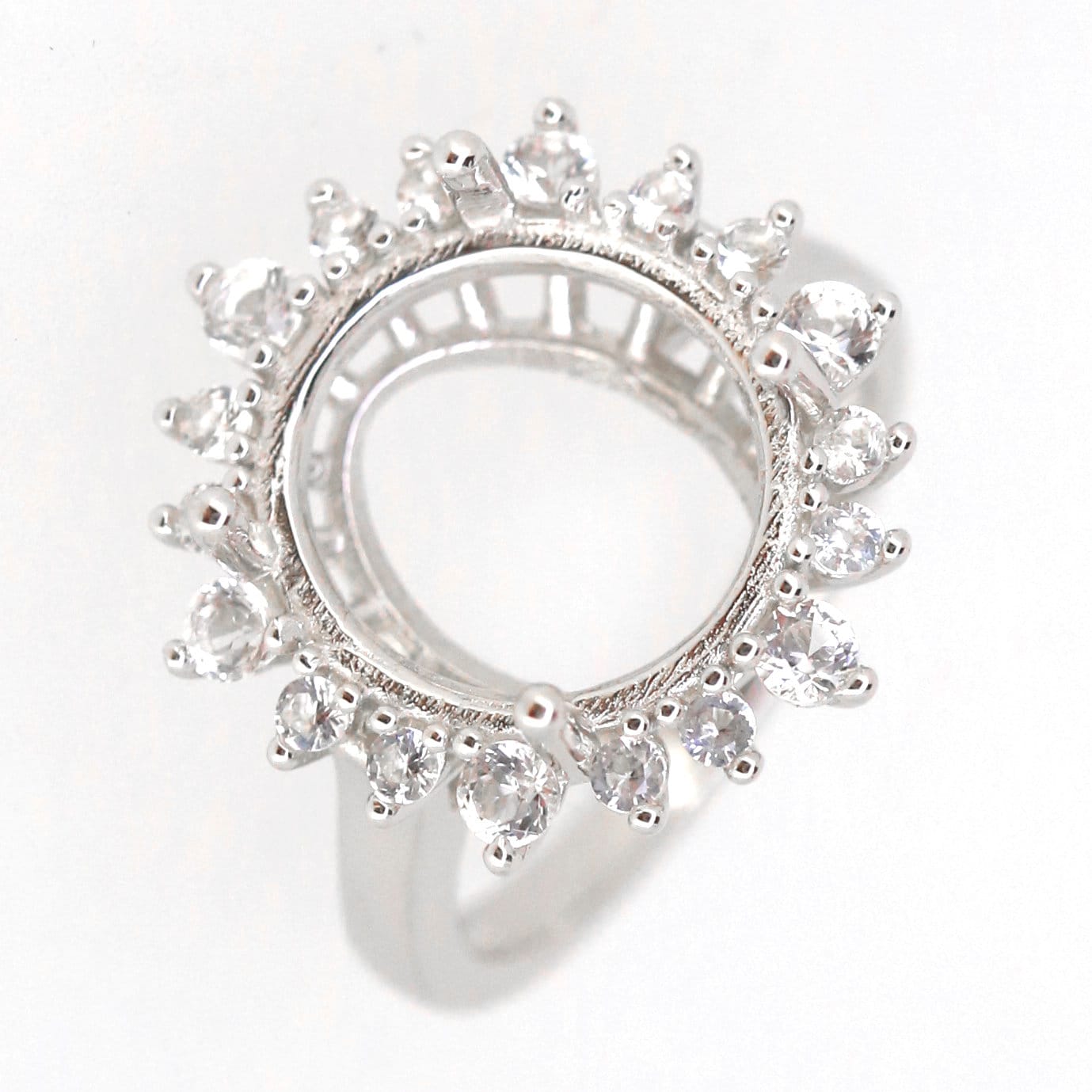 Sterling silver semi mount ring setting featuring an oval halo design with white topaz accents, ready for a custom gemstone.