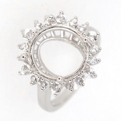 Sterling silver semi mount ring setting featuring an oval halo design with white topaz accents, ready for a custom gemstone.