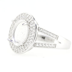 Sterling silver semi mount ring setting featuring white topaz halo and split shank design, suitable for 10x8mm cabochon gemstones.