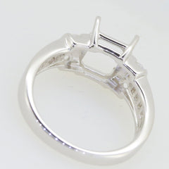 Sterling Silver semi mount ring setting showcasing rear view with space for Emerald OCT 9x7mm and channel set baguette accents.
