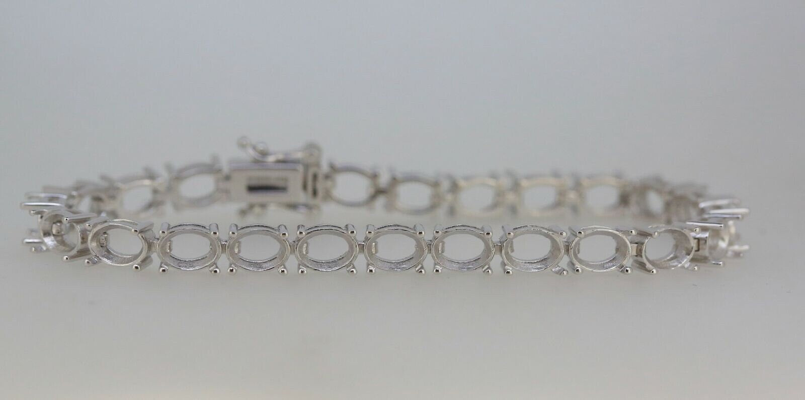 Sterling Silver Semi Mount Tennis Bracelet Setting with oval stone mounts for customizable gemstone options.