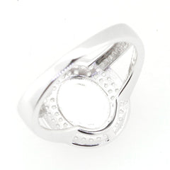 Sterling silver semi mount ring setting for 10x8mm cabochon, featuring a smooth design and halo-like structure.