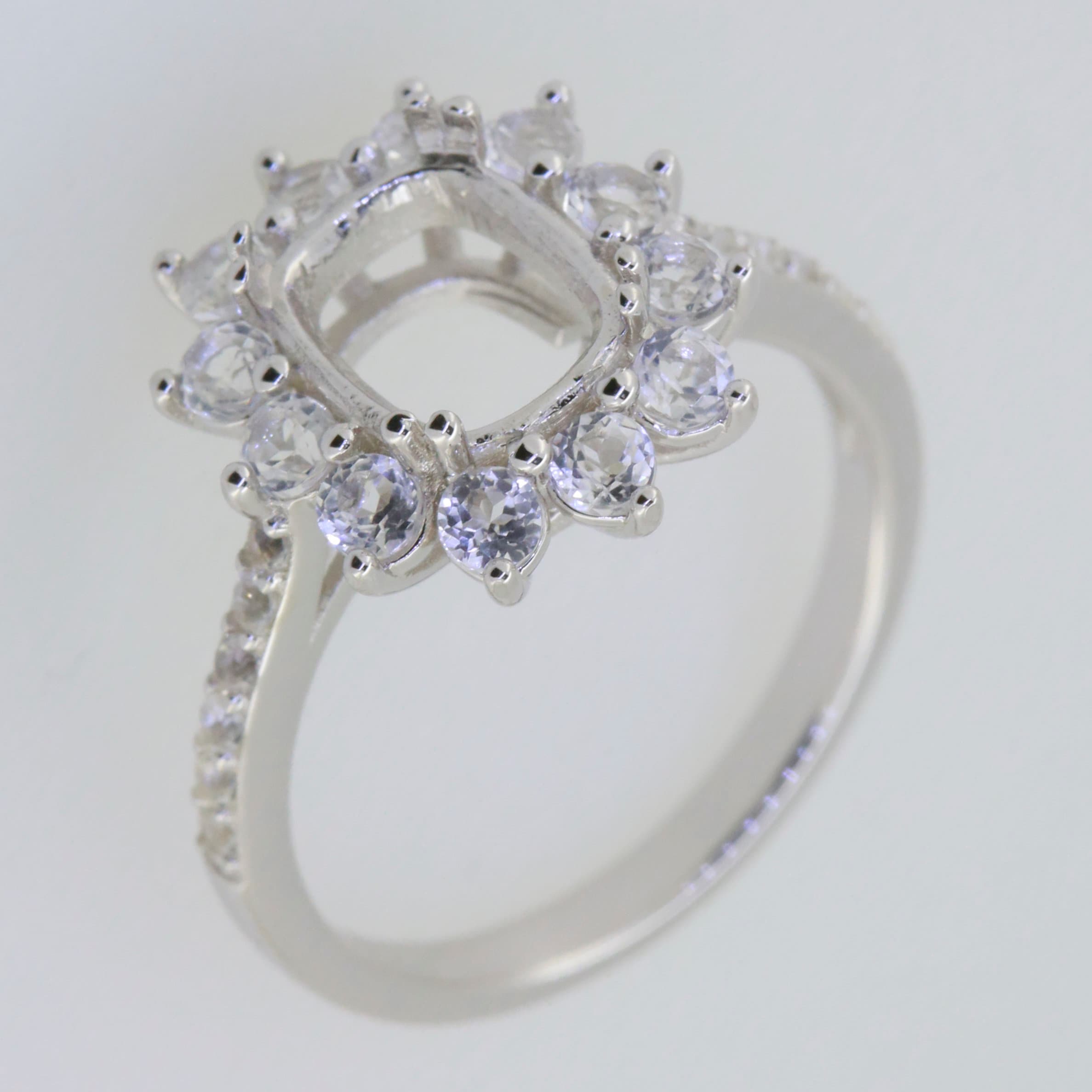 Sterling silver semi mount ring setting with halo of white topaz gems, designed for a 9x7mm cushion center stone.