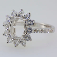 Sterling silver semi mount ring setting with halo design for an emerald, featuring D Color moissanite accents.