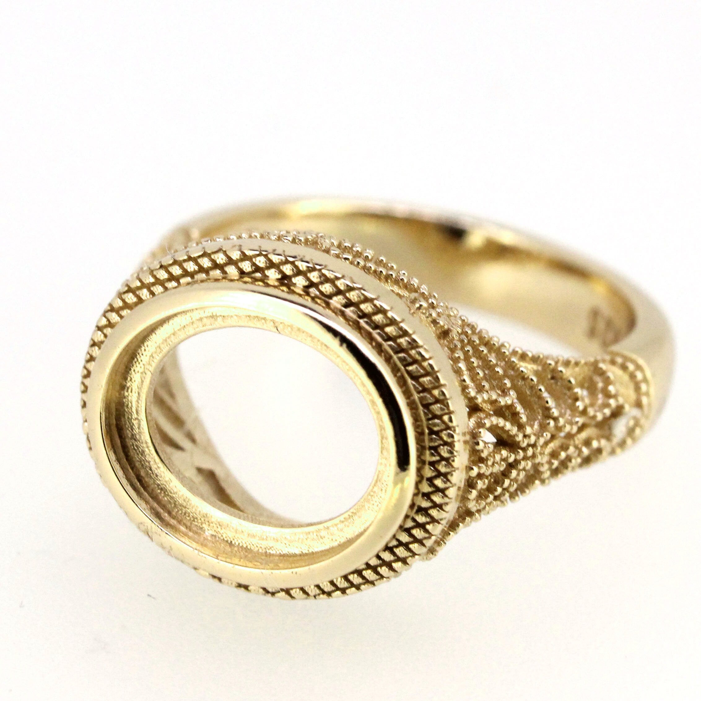 Sterling silver semi mount ring setting with filigree and milgrain detail for 11x9mm oval cabochon gemstone.