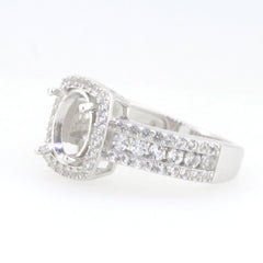 Sterling silver semi mount ring setting with oval halo design and white topaz accent.