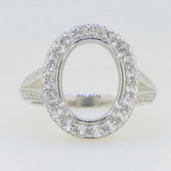 Sterling silver semi mount ring setting with oval halo and moissanite accents, designed for custom gemstone placement.