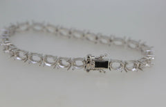 Sterling Silver Semi Mount Tennis Bracelet Setting with oval gemstone placeholders and stainless steel tongue clasp.