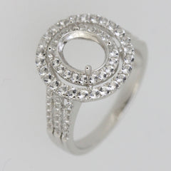 Sterling silver semi mount ring setting with white topaz halo and oval center for custom gemstone placement.