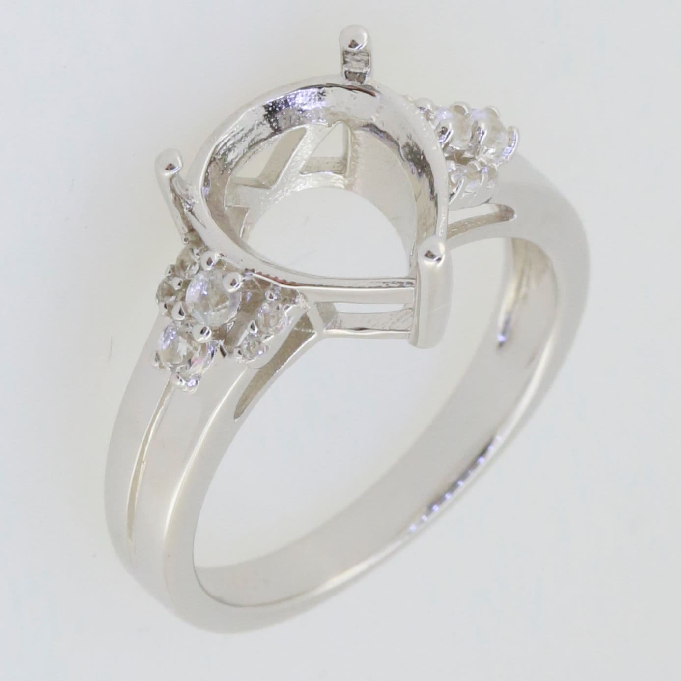 Sterling silver semi mount ring setting with white topaz accents for 11x9mm pear gemstone.