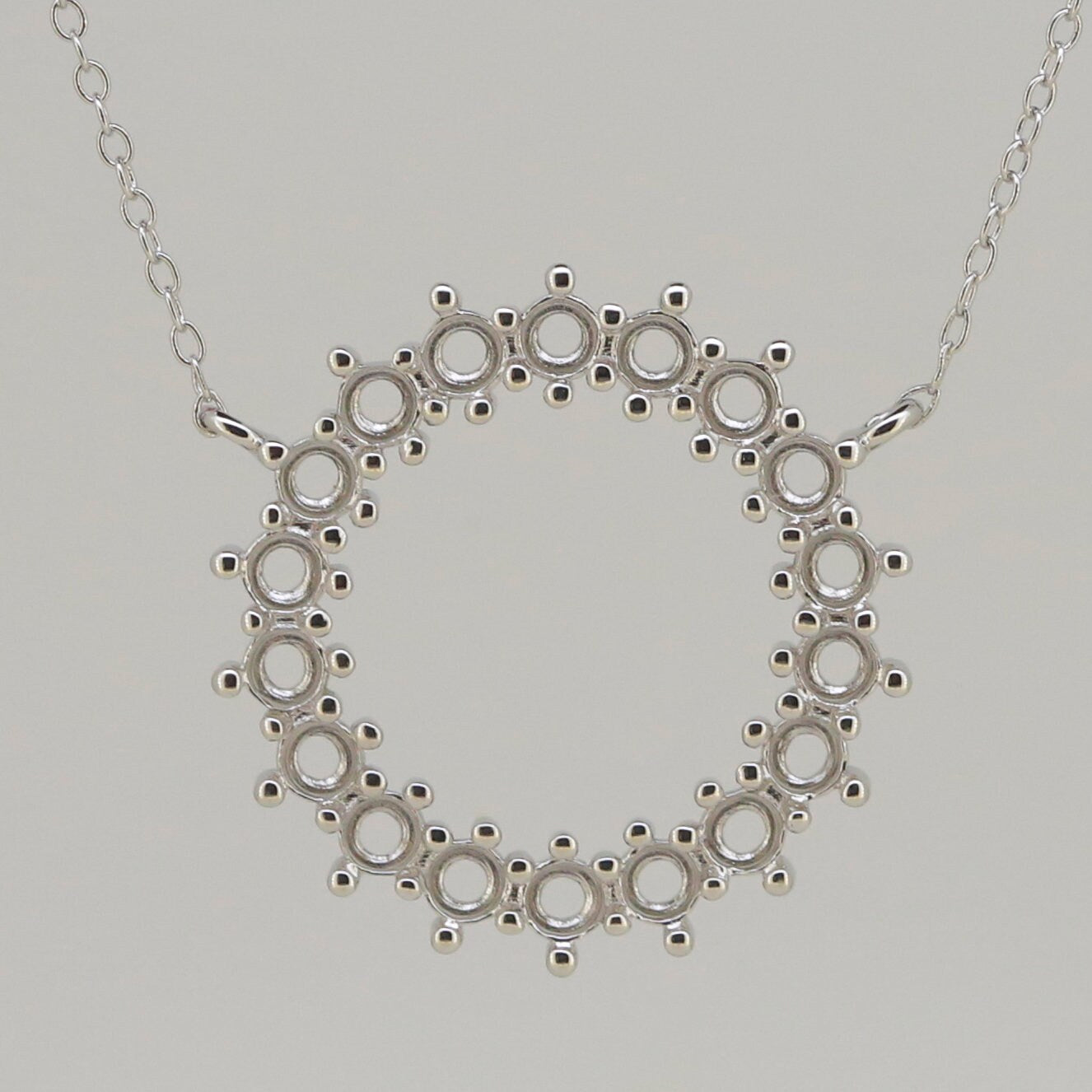 Sterling silver semi mount pendant setting with loops for multi stones and an 18" chain, featuring white topaz.