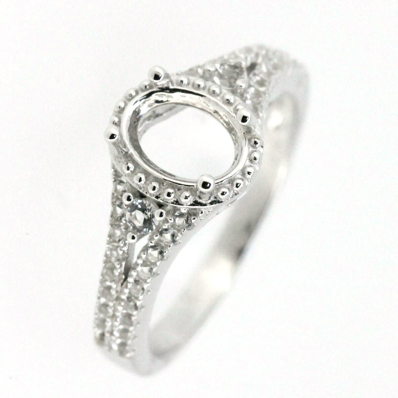 Sterling silver semi mount ring setting with oval gemstone holder and white topaz accents for custom jewelry.