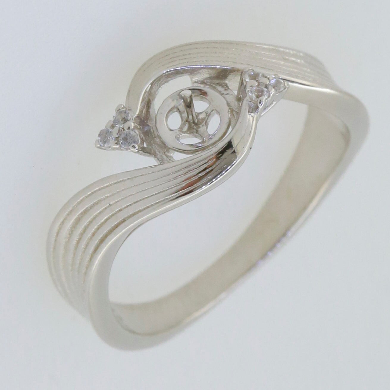 Sterling silver semi mount ring setting with accents, designed for a 6x6mm round pearl and white topaz.