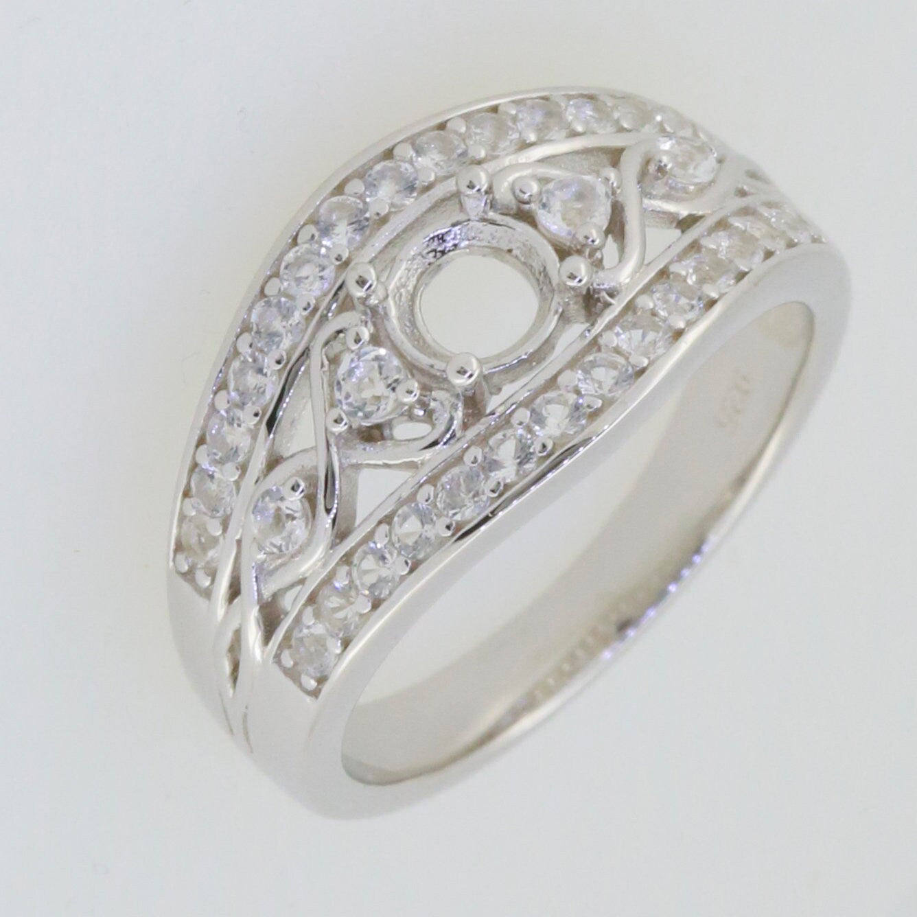 Sterling silver semi mount ring setting featuring round moissanite stones, elegantly designed for engagement.