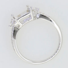Sterling silver semi mount ring setting with moissanite accents and halo design, featuring an emerald cut center.