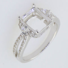 Sterling silver semi mount ring setting with moissanite accents and halo design, perfect for an emerald centerpiece.