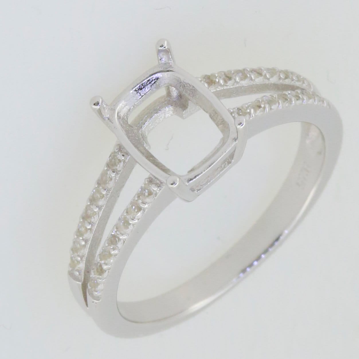 Sterling silver semi mount ring setting with cushion slot for 9x7mm white topaz and split shank design.