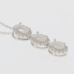 Sterling Silver semi mount pendant setting featuring oval white topaz halo design with three stone arrangement.