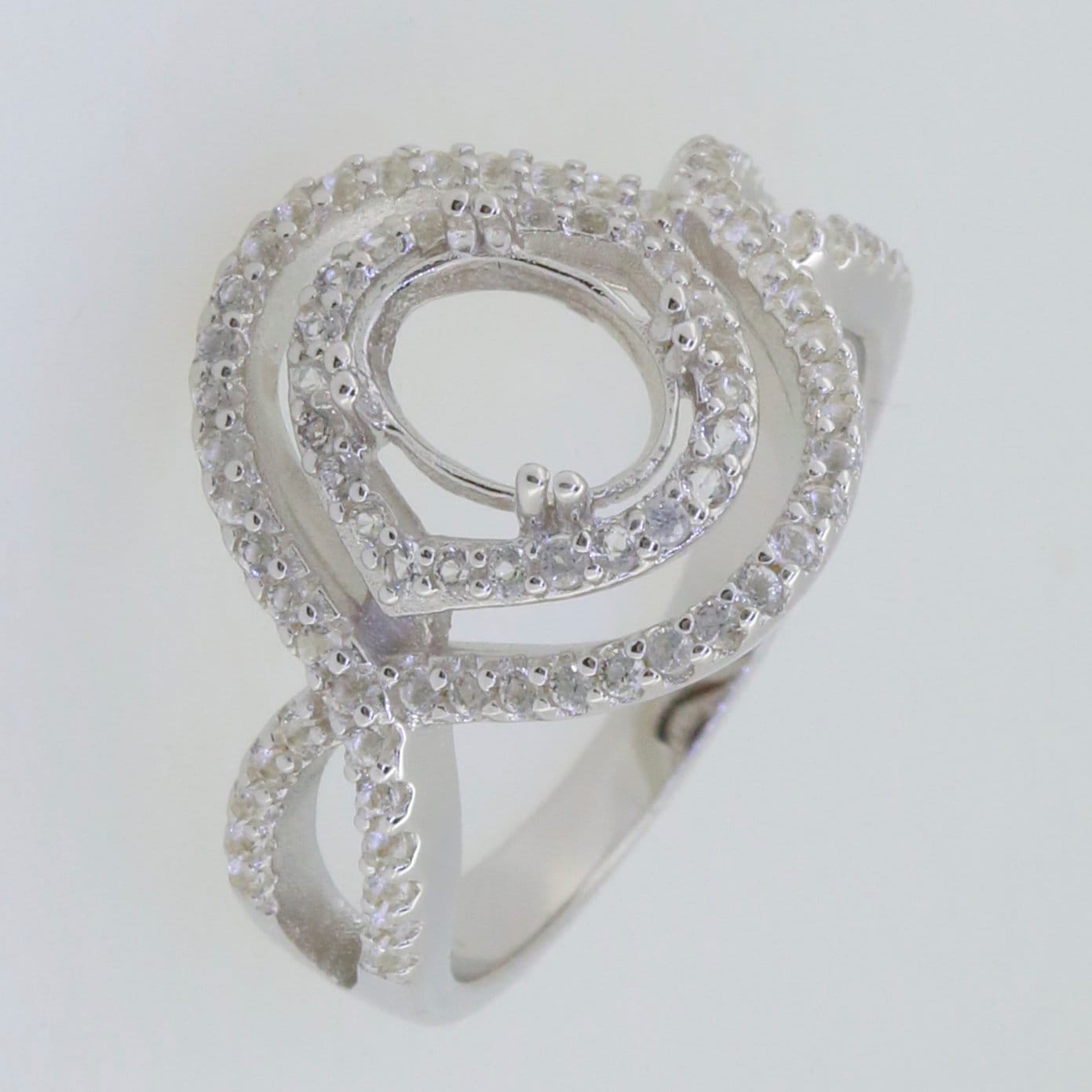Sterling Silver semi mount ring setting with halo design, split shank, ready for custom gemstone installation.