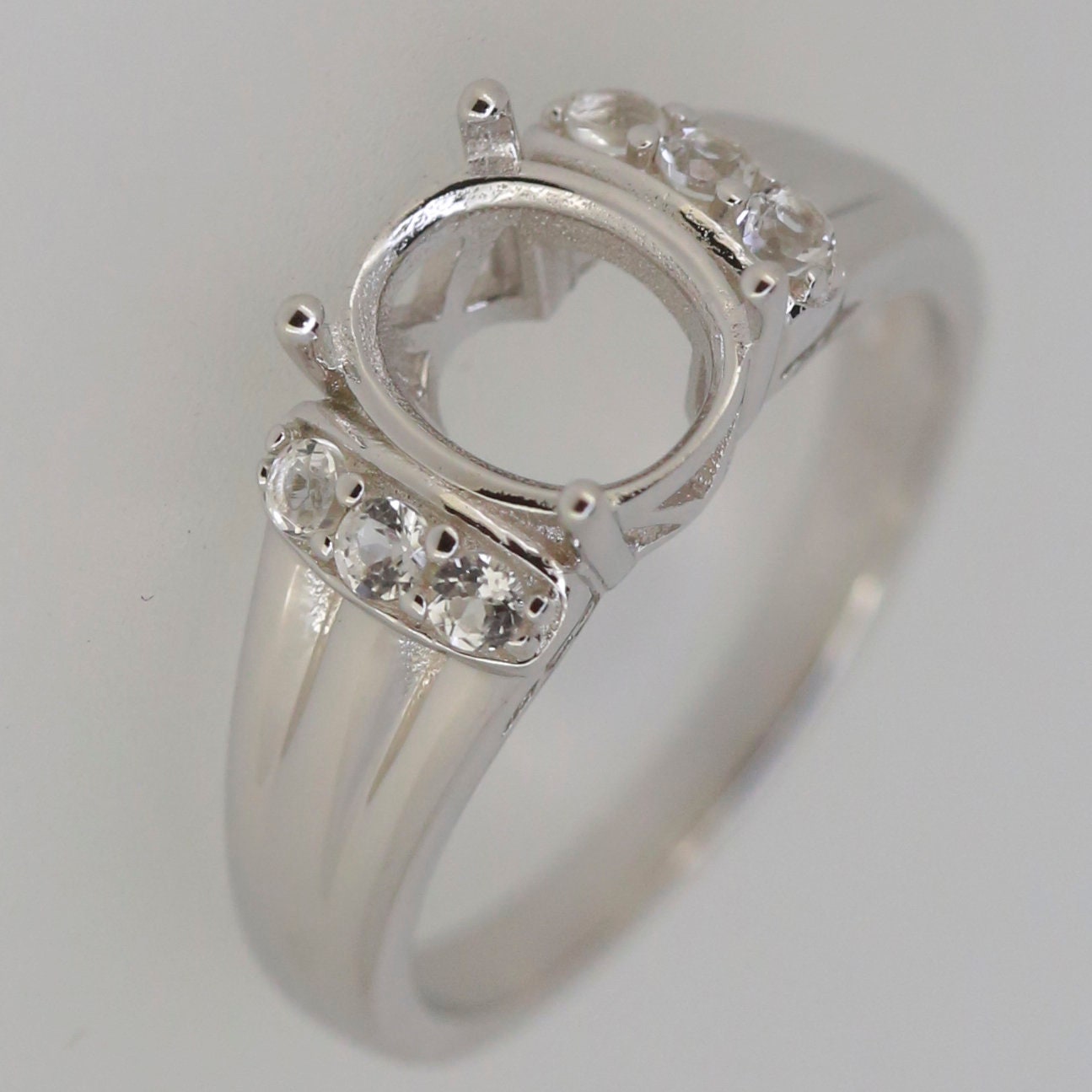 Sterling Silver semi mount ring setting with oval halo, D color moissanite accents, made to order gemstone jewelry.