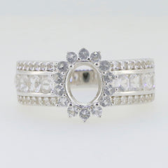 Sterling silver semi mount ring setting with halo and moissanite accents designed for 8x6mm oval gemstones.