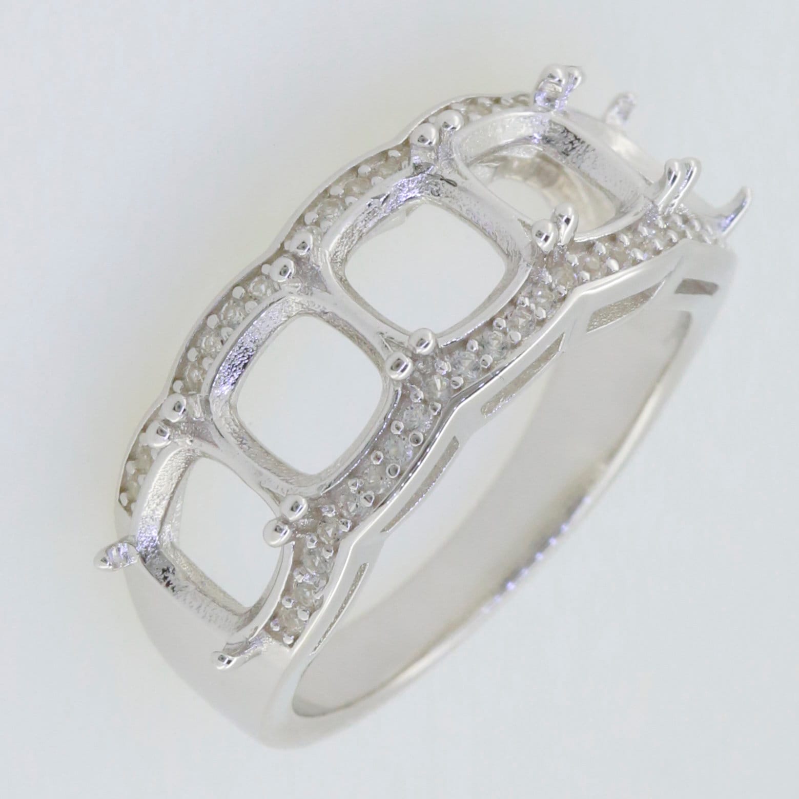 Sterling silver semi mount ring setting with cushion cut design for multi stone, featuring white topaz accents.