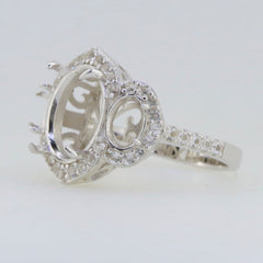 Sterling silver semi mount ring setting with oval stone holders and white topaz halo, ideal for custom jewelry designs.