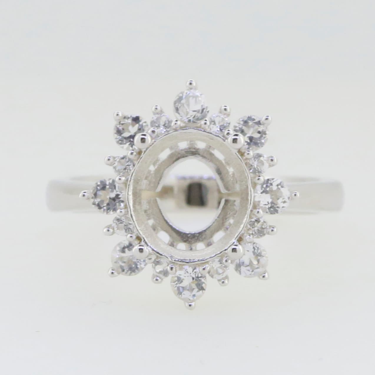 Sterling silver semi mount ring setting with halo and moissanite accents, designed for 10x8mm oval gemstones.