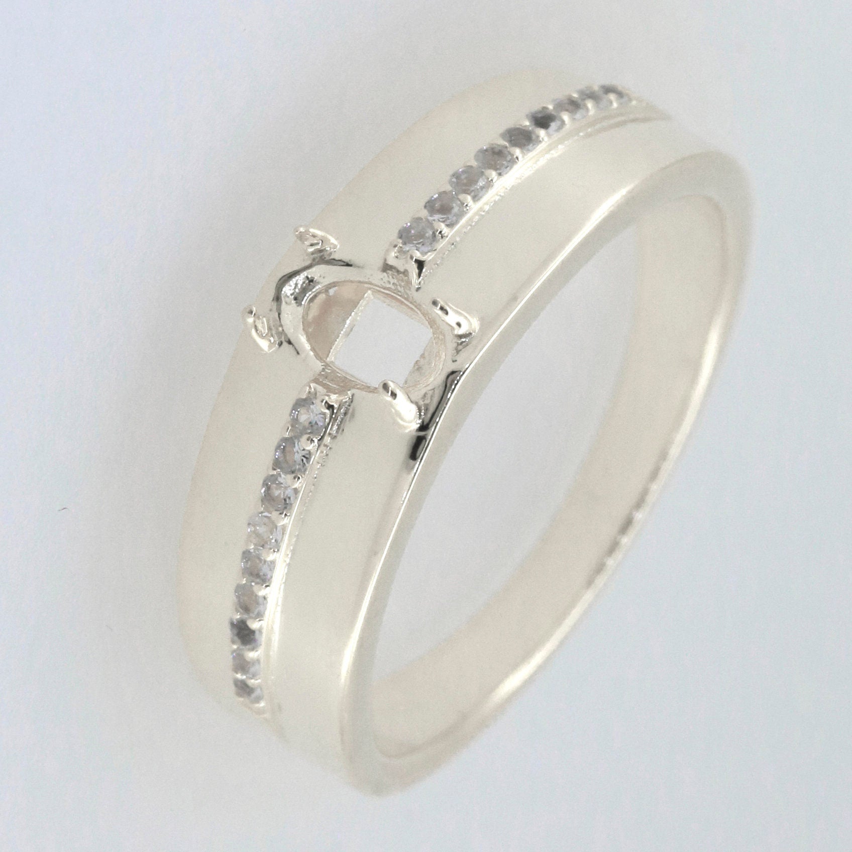 Sterling silver semi mount ring setting with oval gemstone space and Moissanite accents for unisex wear.