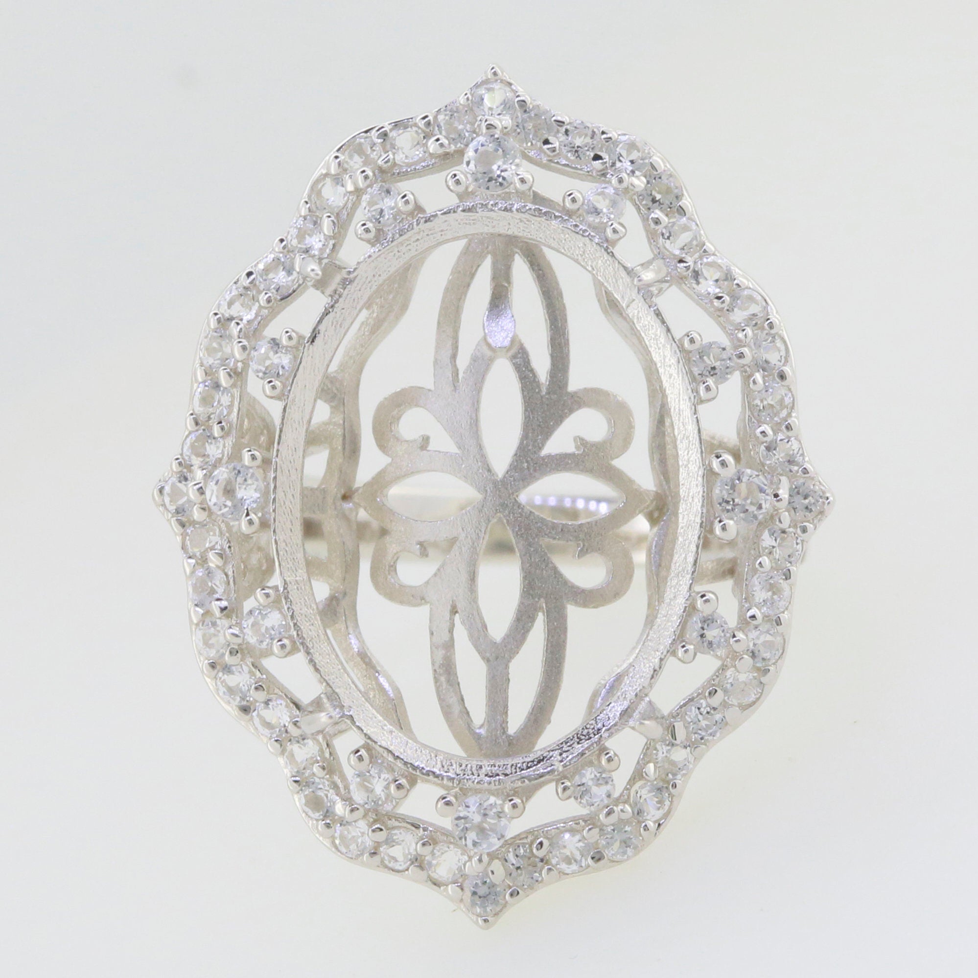 Sterling Silver semi mount ring setting with oval halo design and intricate detailing, ready for custom gemstone placement.