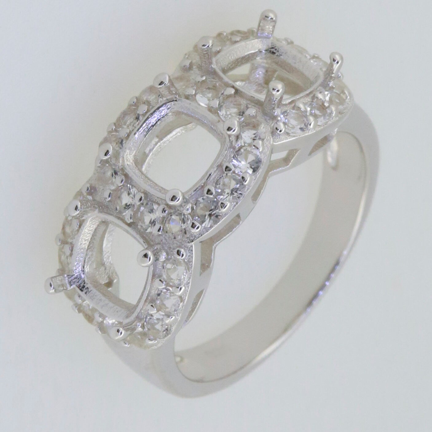 Sterling Silver semi mount ring setting with cushion cut 3 stone halo and D color VVS moissanite gemstones.
