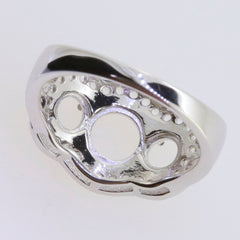 Sterling silver semi mount ring setting with circular cutouts for gemstones, showcasing intricate design details.
