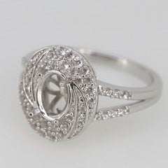 Sterling silver semi mount ring setting with halo design for 8x6mm oval gemstone, featuring split shank and white topaz accents.