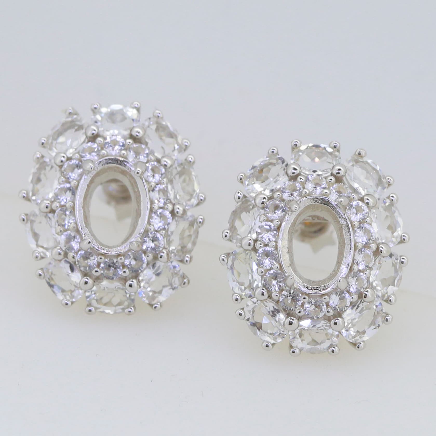 Sterling silver semi mount earrings setting featuring double halo design with white topaz accents, for custom gemstone options.