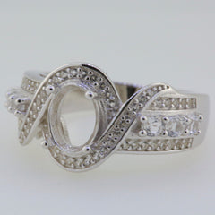 Sterling silver semi mount ring setting with twisted shank and white topaz gemstones, designed for an oval 8x6mm stone.