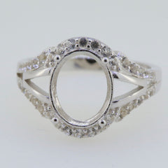 Sterling silver semi mount ring setting with oval moissanite accent and split shank design, ready for customization.