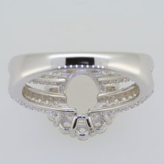 Sterling silver semi mount ring setting for oval 9x7mm gemstone with split shank halo design and white topaz accents.