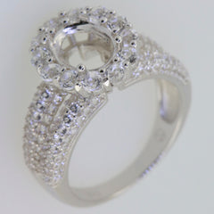Sterling silver semi mount ring setting with halo, designed for oval 9x7mm gems, featuring White Topaz accents.